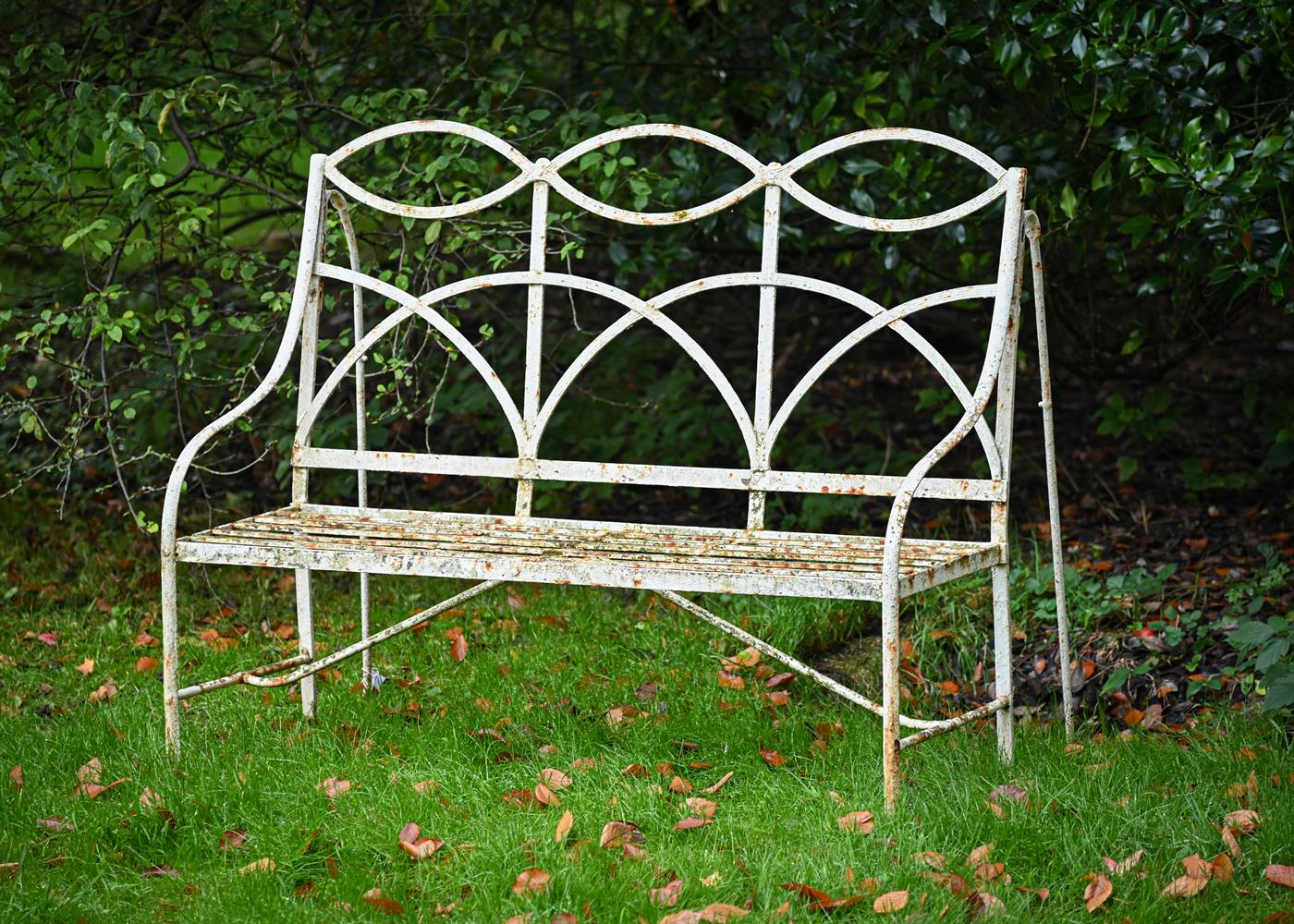 A REGENCY WHITE PAINTED STRAPWORK GARDEN SEAT, EARLY 19TH CENTURY