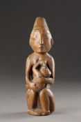 A RARE AND EARLY NORTHWEST COAST CARVED WOOD MATERNITY FIGURE KWAKIUTL