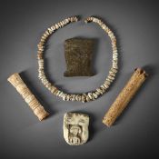 A GROUP OF FIVE ANTIQUITIES TO INCLUDE: A roundel carved pierced section of bone