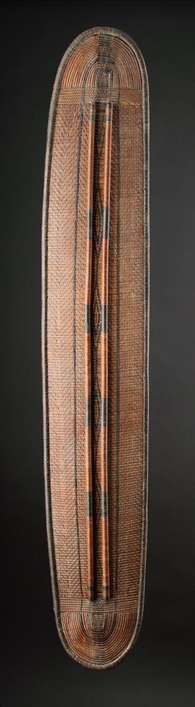 A CENTRAL AFRICAN MONGO SAKA PEOPLES LONG OVAL WICKERWORKED SHIELD, DEMOCRATIC REPUBLIC OF CONGO