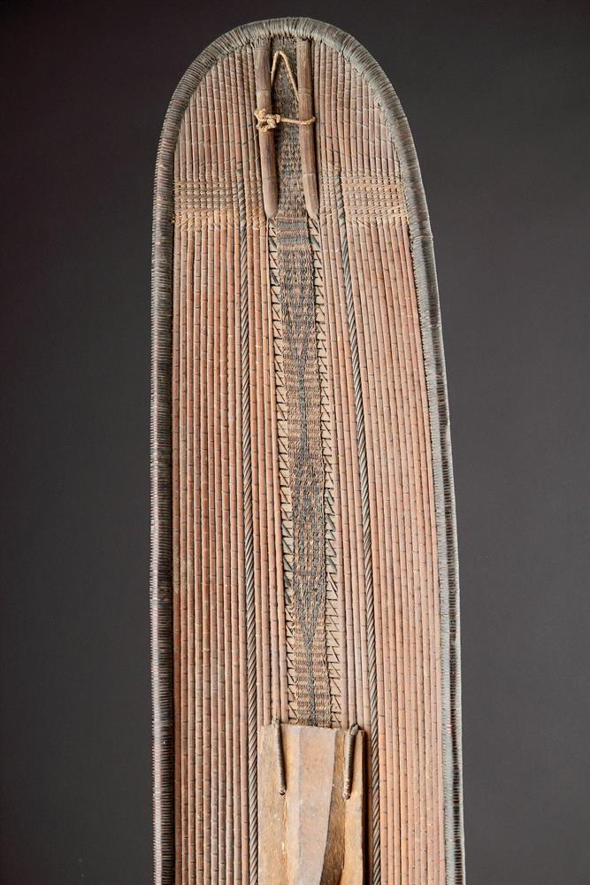 A CENTRAL AFRICAN MONGO SAKA PEOPLES LONG OVAL WICKERWORKED SHIELD, DEMOCRATIC REPUBLIC OF CONGO - Image 5 of 7