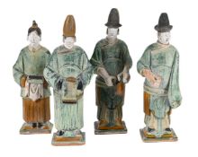 FOUR CHINESE POTTERY FIGURES OF ATTENDANTS, MING DYNASTY