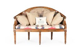 A FRENCH CANED CARVED BEECH SOFA, 19TH CENTURY