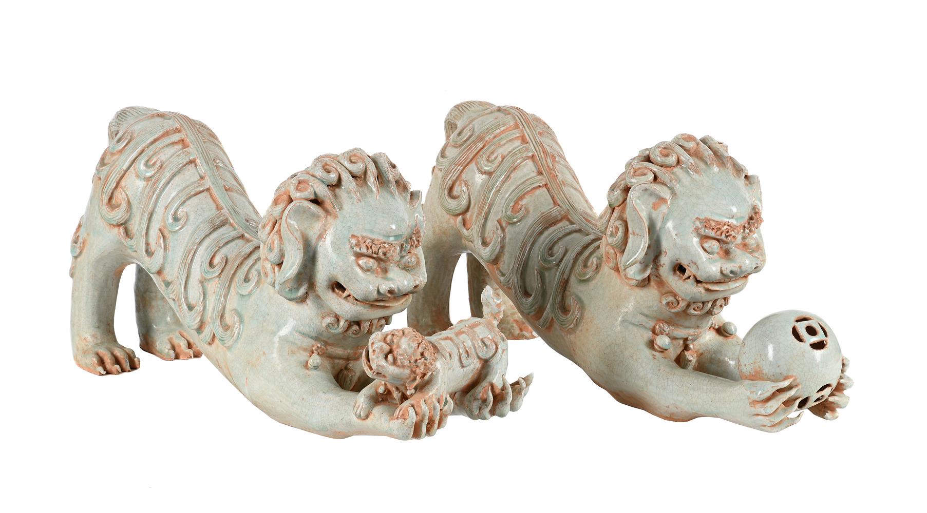 A PAIR OF CHINESE PORCELAIN CELADON GLAZE MODELS OF LIONS WITH A CUB OR A BOCADE BALL20TH CENTURY