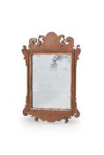 A GEORGE II MAHOGANY AND PARCEL GILT FRET MIRROR, CIRCA 1750