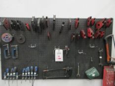Wall mounted shadow board with contents including screwdrivers, magnetic corner clamps