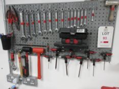 Wall mounted tool board with contents including spanners, mallets, Hex keys, LED light, hammers,
