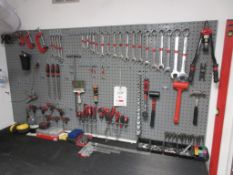 Wall mounted tool board with contents including screwdrivers, spanners, socket set, hand files,