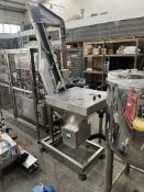 Lid hopper, unscramble and elevator to gravity feed chute to capper. Hopper 700x600. 1500 elevator.