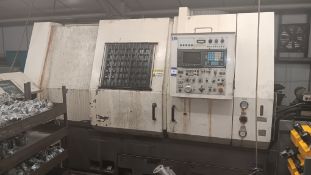 Unbadged CNC turning centre with Fanuc 0-T series control and fitted swarf conveyor.  Purchaser must