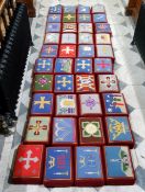 A harlequin set of fourty ecclesiastical hassocks / worshipping prayer stools, each with unique