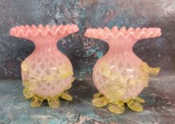 A pair of Victorian satin glass globular vases, with flared frilly rims, applied with vaseline