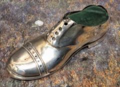 A George V silver novelty pin cushion, as a shoe, 12.5cm wide, Chester 1912