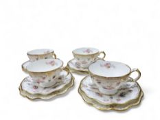 A set of four Royal Crown Derby Royal Antoinette pedestal teacups, saucers and side plates,  printed