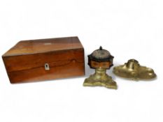 An early 20th century brass inkwell, cartouche base cast with ribbon tied foliage, 16cm wide, c.