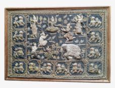 A substantial Burmese textile panel, decorated in relief with elephants, temple dogs, deities and