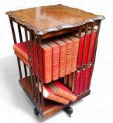 An early 20th century mahogany rotating bookcase, shaped square surface, holding eight open shelves,