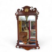 A George II Revival Vauxhall mirror, parcel gilt pierced shell motif and rounded rectangular looking