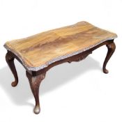 A quarter veneered shaped rectangular coffee table, boldly carved acanthus capped cabriole legs,