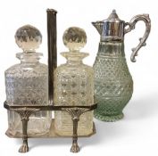 An E.P.N.S. two bottle decanter stand, canted rectangular, paw feet, the decanters with globular