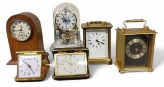 An early 20th century domed clock, 8-day movement, the case with shell patera, 15.5cm high, c.1910;