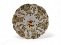A Rockingham shaped circular plate, painted by John Randall, with fanciful bird, the sides with