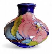 A Moorcroft Magnolia pattern compressed ovoid vase, tube lined with a large pink flowerheads on a