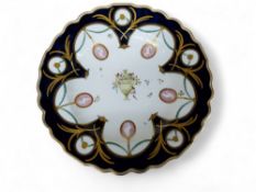 A  Chelsea-Derby shaped circular plate, painted with urn to centre with classical busts in oval