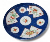 A Bow circular saucer, painted in underglaze blue with fan-shaped and circular reserves of floral
