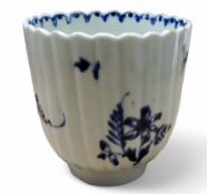 A Lowestoft fluted coffee cup,  in underglaze blue with  floral sprays,  ribbed loop handle, c.