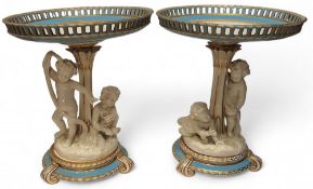 A pair of mid 19th century Minton figural comports, the pierced circular dishes, banded in