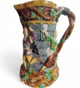 A Minton majolica 'tower' jug, relief moulded with medieval dancers, naturalistic vine handle,