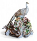 A Bloor Derby peacock, modelled by John Whitaker, standing with tail down, picked out in gilt and