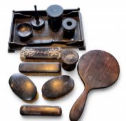 An early 20th century ebonised dressing table set, comprising brushes, ring tree, cylindrical