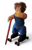 A Schuco clockwork Rolly Monkey,  blue felt dungarees - red/white striped shirt, black boots with
