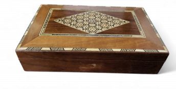 A 20th century Indo-Persian rectangular box, the cover with warriors, inlaid with stars to border