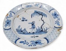 An English Delft circular plate, probably London, decorated in under glazed blue with oriental