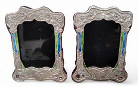 A pair of Art Nouveau style shaped rectangular sterling silver and enamel easel photograph frames,