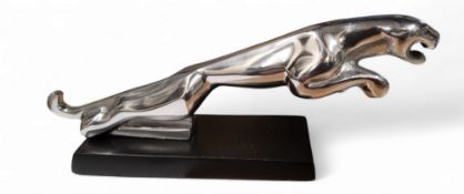 A replica silver coloured Jaguar car mascot,  black  plinth, 31cm long
