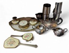 An early 20th century gilt metal and embroidered dressing table set; silver plated three piece tea