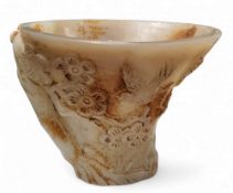 A Chinese 'white jade' libation cup, with prunus and birds, 10cm high
