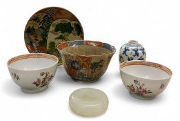 A pair of 18th century  Chinese tea bowls, decorated in the famiile rose manner, with scattered