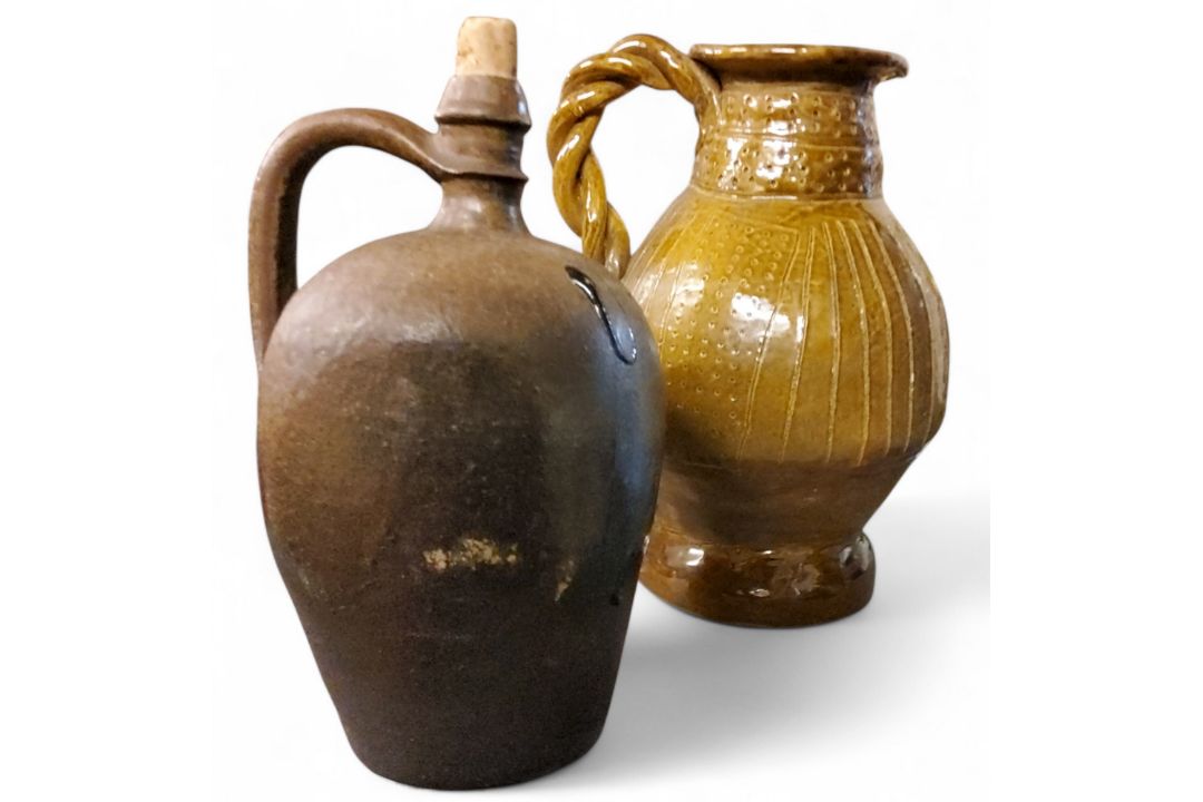 A 20th century stoneware ewer, incised in with lines and dots, twisted handle, 30cm high;