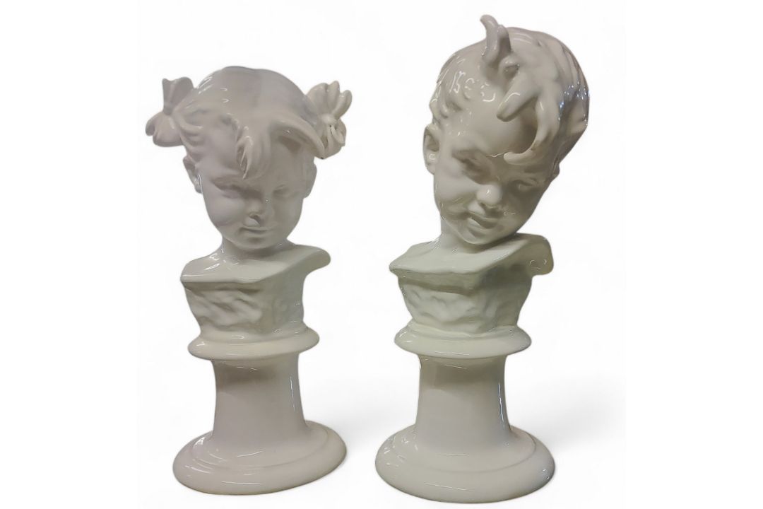 A pair of 20th century busts, in the white, of a boy and a girl, on pedestals, 31cm high,  marked