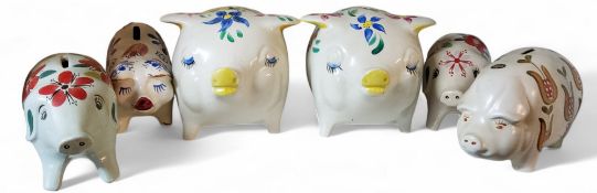 Two large Arthur Wood money boxes, in the form of comical pigs, painted in colours with stylised