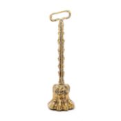 A 19TH CENTURY BRASS DOOR PORTER