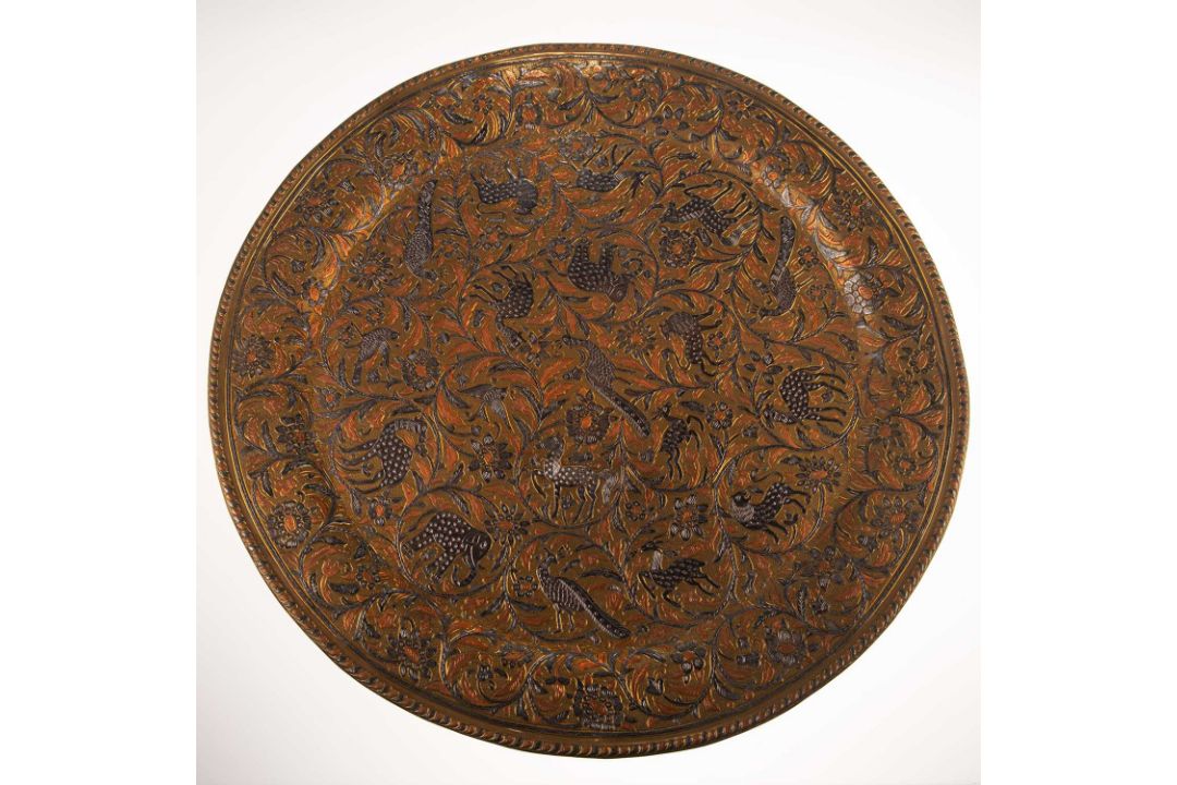 A LARGE INDIAN SILVER AND COPPER OVERLAID BRASS CHARGER