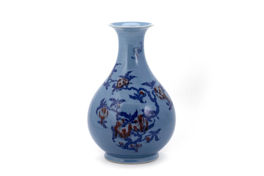 AN UNDERGLAZE BLUE AND RED DECORATED BLUE-GLAZED PEAR-SHAPED VASE - Image 1 of 3