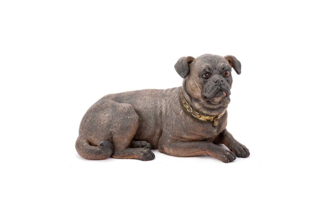 AN AUSTRIAN PAINTED EARTHENWARE MODEL OF A PUG DOG
