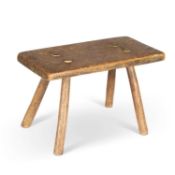 A 19TH CENTURY PRIMITIVE ELM STOOL